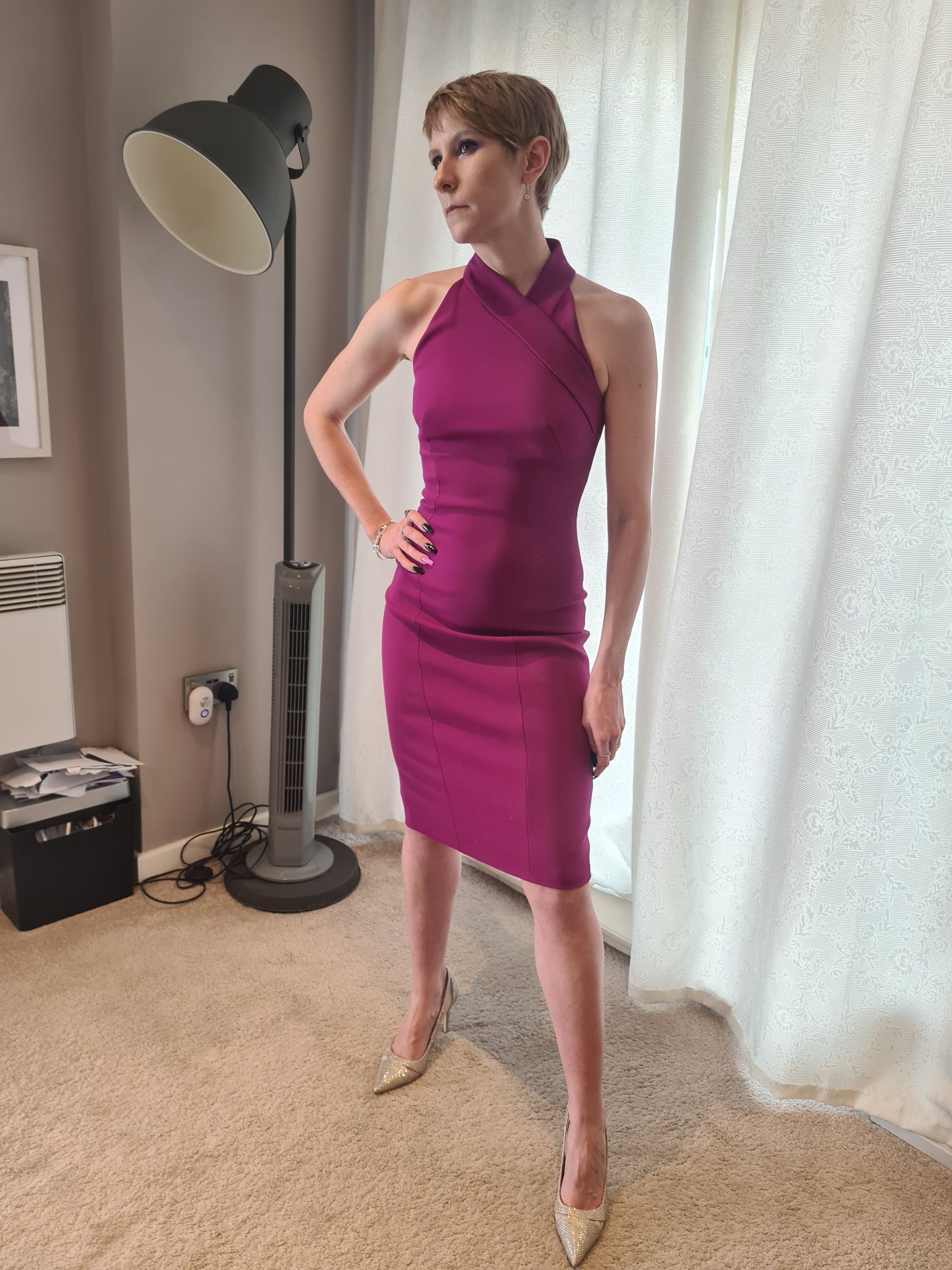 Women posing with fuchsia, mid length dress. 